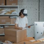 Image of an entrepreneur girl holding a clipboard ready to ship a package.
