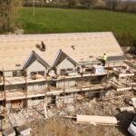 A house where the roof is being installed from top view.