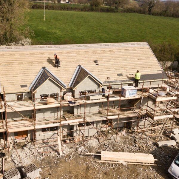 A house where the roof is being installed from top view.